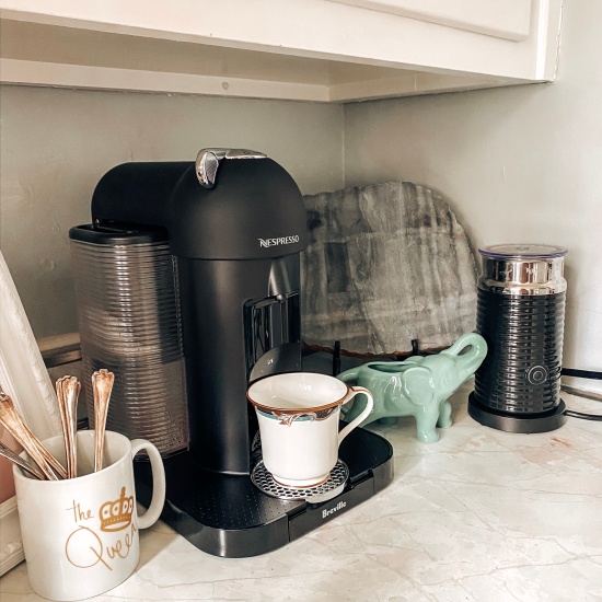 Photo of Candace's "coffee corner" with her Nespresso coffee machine, the Aeroccino, and coffee making supplies.